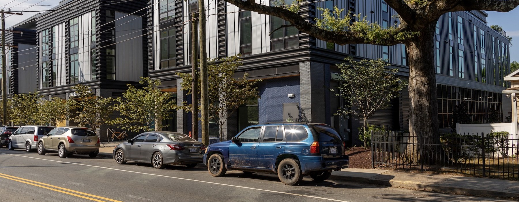 a street view of a building with cars parked on the side of it