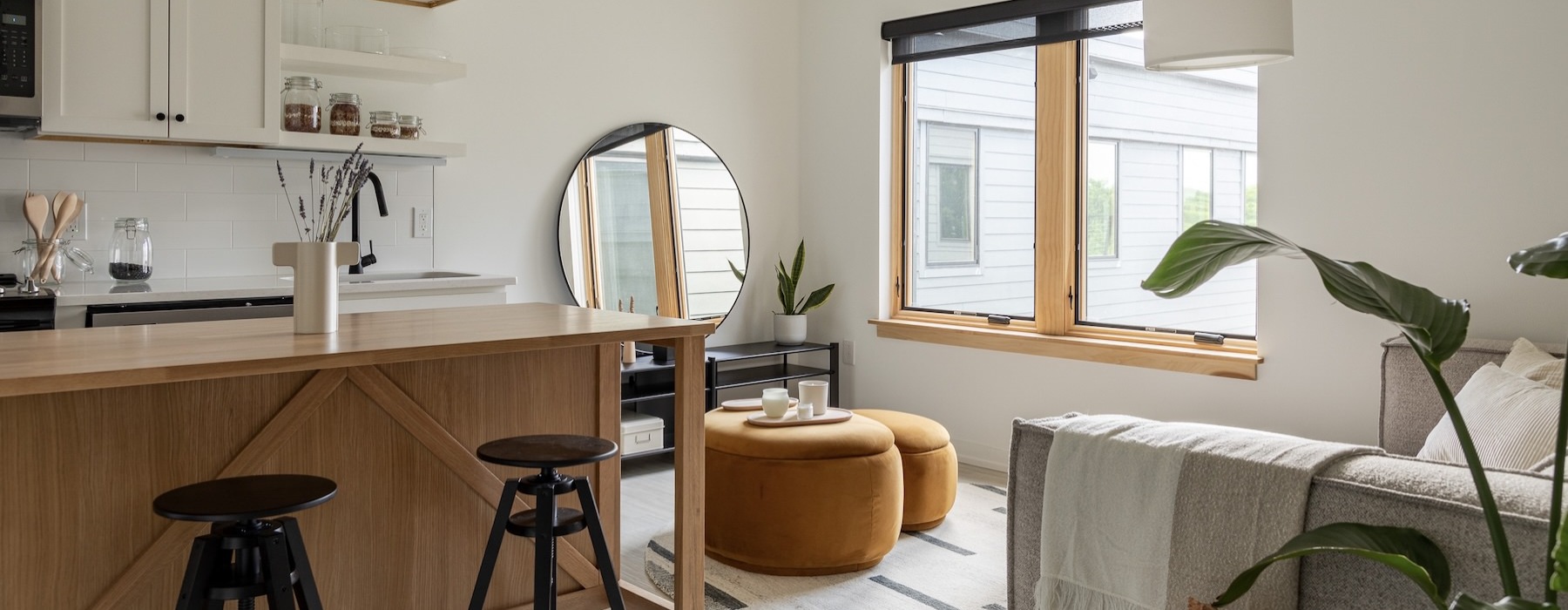 a kitchen with white cabinets and an island with barstools