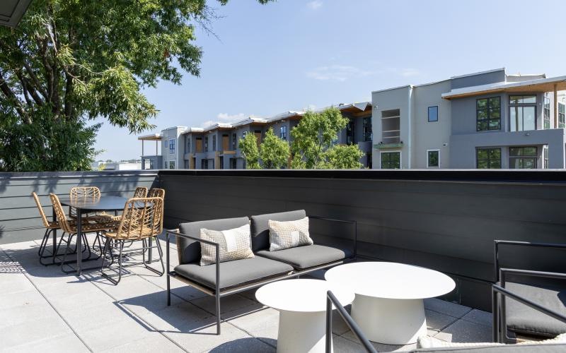 a patio with chairs and tables