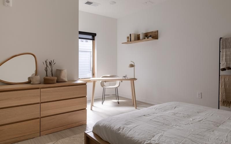 a bedroom with a bed and wardrobe and a desk